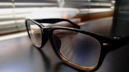 photo of sunglasses on the table. selective focus