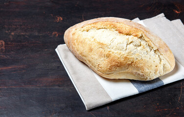 Bread on a wooden background. Fresh bakery on dark kitchen table
