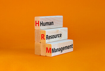 HRM, Human resource management symbol. Words HRM, Human resource management symbol on blocks on a beautiful orange background. Business, HRM, Human resource management symbol concept. Copy space.