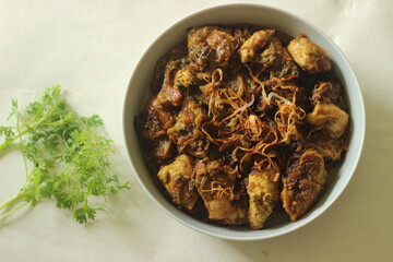Ghee roast chicken prepared in Kerala style. Chicken marinated with yogurt and spices, cooked in...