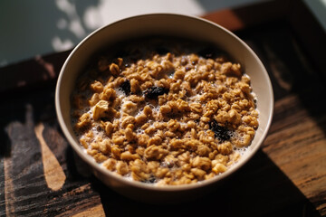 Bowl of oatmeal and corn flakes with milk for breakfast