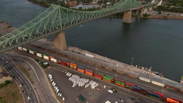 Aerial view of architectural landmark Jacques Cartier bridge over the Saint Lawrence river during summer in Montreal, Quebec, Canada.
