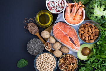 Top view of food sources of omega 3 on the black  background. Copy space. Food hight in fatty acids.