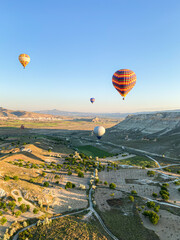 Colorful balloons fly over Cappadocia, Turkey. Hot air balloon flight at sunrise.