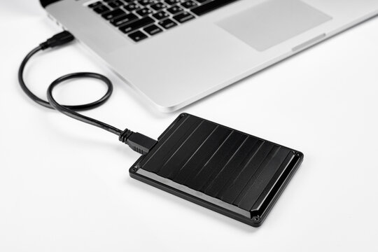 An external USB hard disk drive isolated on a white background. External Hdd drives and flash drives. External hard disk drive for connect to laptop, transfer or backup data between computer and HDD.