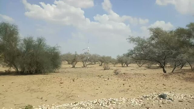 Thar desert as seen from car window. Barren land , sand dunes of Jaisalmer, Rajasthan, India.