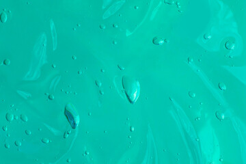 Cosmetics smear with bubbles on the blue background.Cosmetic texture of aloe vera or antibacterial gel.Good as mockup with copy space.Advert banner.