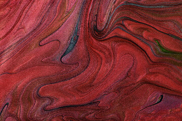 Beautiful shimmer stains of liquid nail polish.Red,green and blue colors.Stripy paint texture.Nail lacquer flow background in fluid art technique.Minimalism concept.Copy space,horizontal photography.