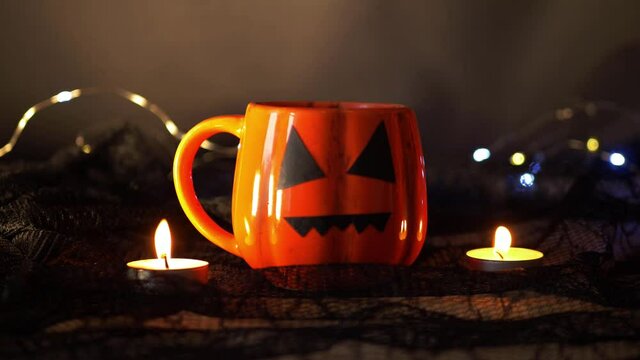Witches brew in pumpkin mug at Halloween 