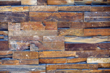 Full frame close-up partial view of a wall built of wooden bricks