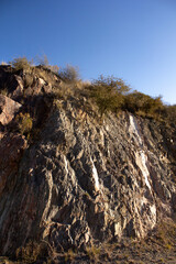 Flagstone wall in landscape with blue sky