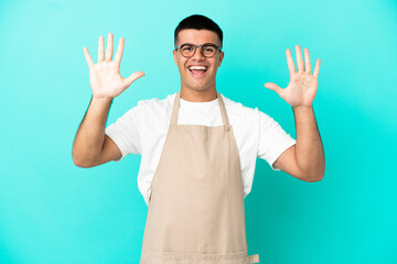 Naklejka premium Restaurant waiter man over isolated blue background counting ten with fingers