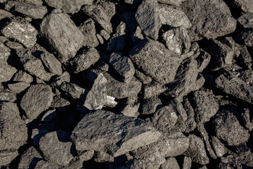 Pale black coal, close-up, heating season, coal industry.