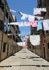 Fototapeta na wymiar clothes hung out to dry in the sun in the narrow street of the Mediterranean city