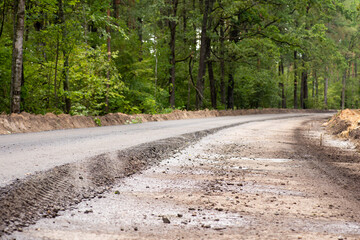 Making new asphalt road in the countryside. One lane is ready while the other one needs a finishing...