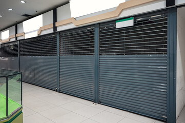 Abandoned closed shutter shop in department store