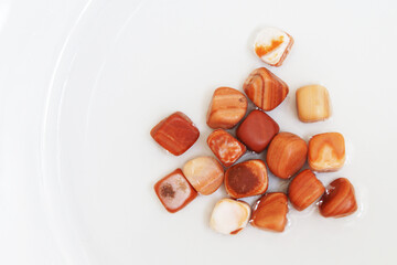 A scattering of beautiful smooth natural stones. Flint on a white background.