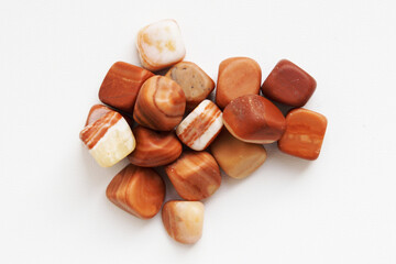 A scattering of beautiful smooth natural stones. Flint on a white background.