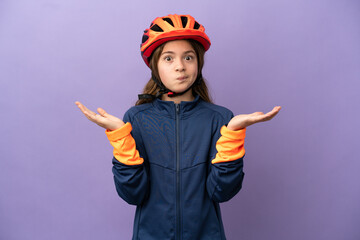 Little caucasian girl isolated on purple background having doubts while raising hands
