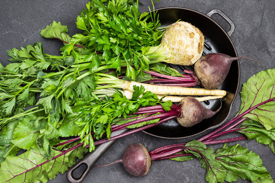 Celery, parsley, beets with tops in pan.