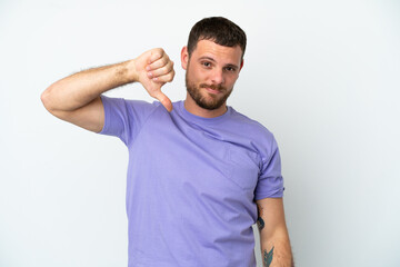 Fototapeta premium Young Brazilian man isolated on white background showing thumb down with negative expression