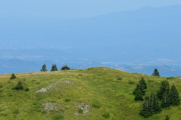 a man on a hill in the mountains