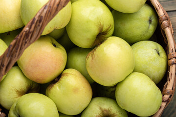 Close-up of ripe apples in a basket.