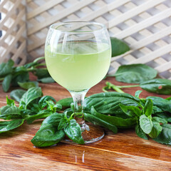 Glass of lemonade made from green basil and lemon - 457186107