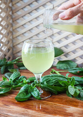 Glass of lemonade made from green basil and lemon - 457186109