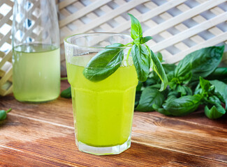 Glass of lemonade made from green basil and lemon - 457186141