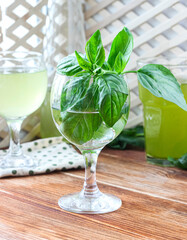 Glass of lemonade made from green basil and lemon - 457186142