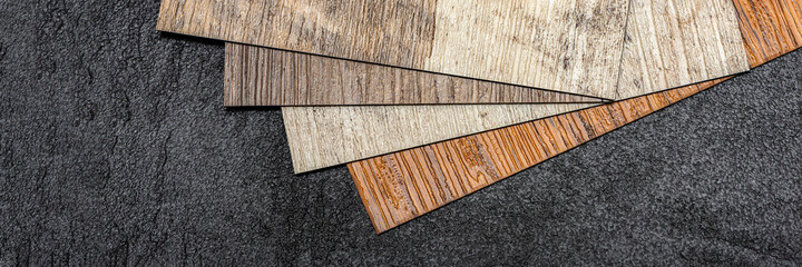 PVC vinyl sample. Vinyl floors. The swatches are brown with a woody texture. Copy space.