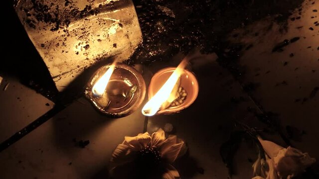 Two oil candles on a street altar somewhere in India.. Traditions of Hinduism. Fire for the deity