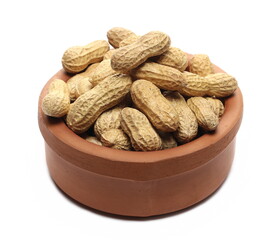 Shelled peanuts in clay bowl isolated on white background
