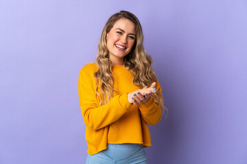 Young Brazilian woman isolated on purple background applauding