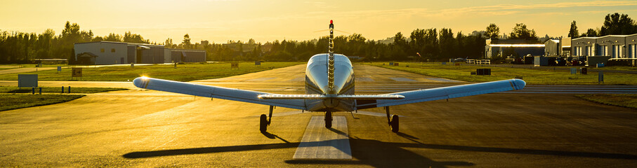 Small plane ready to take off at sunrise. - obrazy, fototapety, plakaty