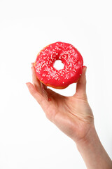 Woman hand holds red donut over white