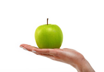 Woman hand holds green apple over white
