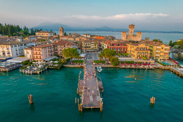 Aerial panoramic view of Sirmione city old town on lake Garda in Lombardy, Italy. Evening photo with a castle in a center