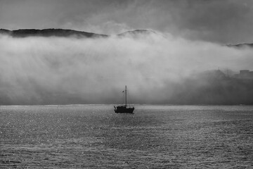 Silhouette Boat In Fog. Fishing boat in the Mediterranean early  in the morning in Summer. Stock Image