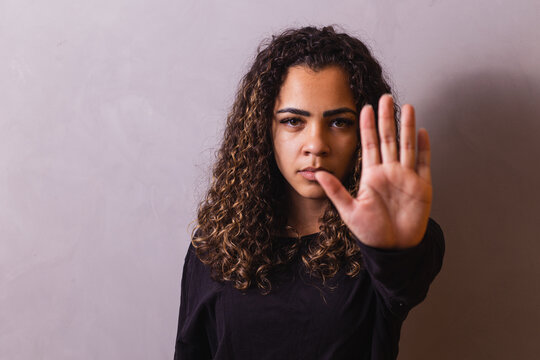 Confident black woman protesting against racial discrimination isolated on yellow background - Young diverse african woman showing black lives matter gesture - stop racism, human rights concept