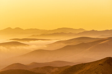 Yellow sunset in Mountain layers, fog, 