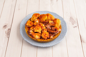 Popular Spanish tapa of Galician octopus with pepper, olive oil, coarse salt and cooked cachelos