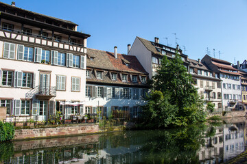 Fototapeta na wymiar Beautiful cityscape of French and German inspired traditional half- timber framed homes along the idyllic Ill River in Strasbourg, France