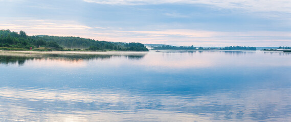 Beautiful panoramic landscape in the misty morning on the river. Svir river, Leningrad region, Russia.