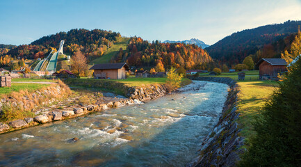 partnach river with bend and view to famous ski jump, autumnal landscape Garmisch