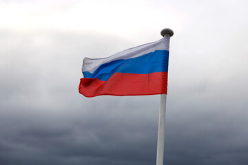 Russian Federation flag on a sky background.