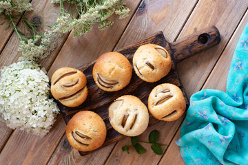 Sweet dessert: airy cupcakes with pears on a wooden table. Muffins with pears for breakfast. Close-up.