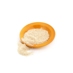 Spilled rice and yellow plate isolated on a white background