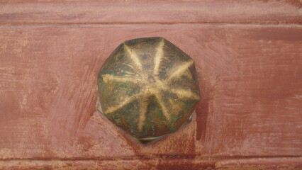 Vintage brass door handle on a very old door, Greece, Syros island, Ermoupoli